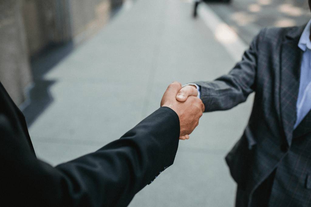 two businessmen shaking hands upon agreement